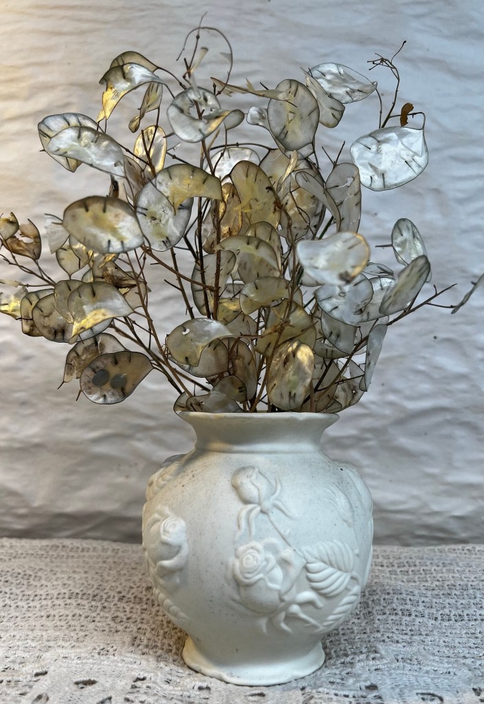Honesty seed heads in a white vase