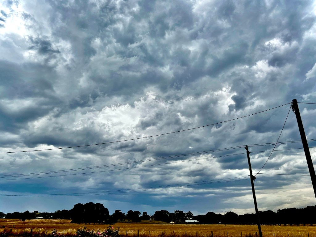Intense, grey, stormy skies over a country road