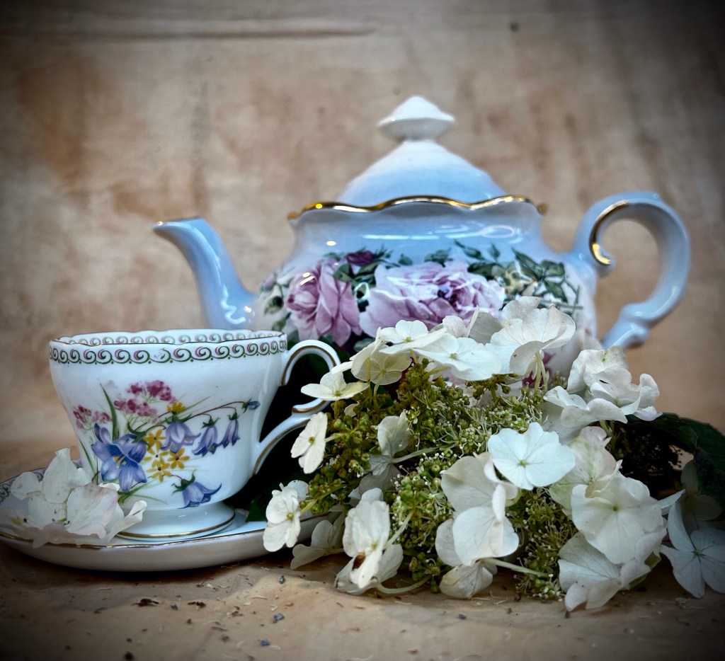 Cup and teapot with hydrangea flowers