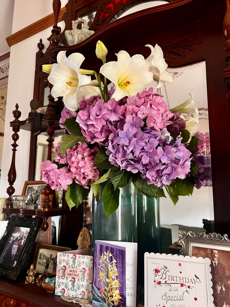 Mantelpiece with a floral arrangement and cards
