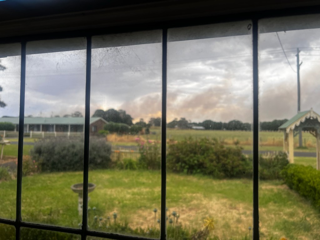 Smoke seen out a window from a bushfire 